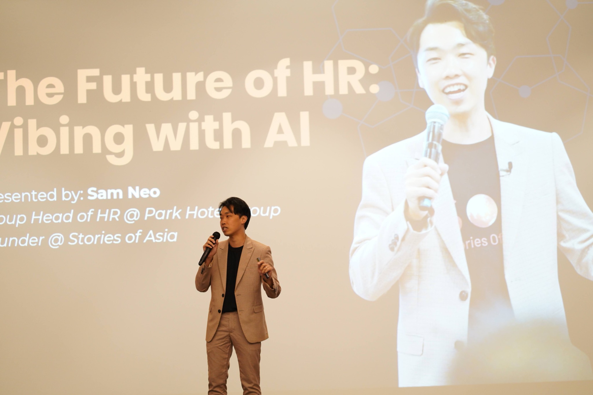 Sam Neo sharing insights on stage at an event